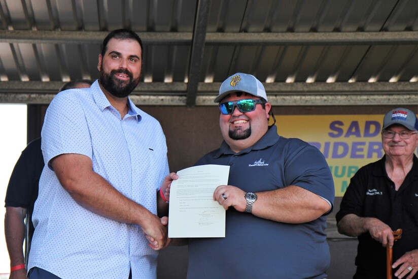 Clare Warden Yvon LeBlanc and Church Point Mayor Ryan “Spanky” Meche hold up the signed twinning agreement renewal between the two communities.